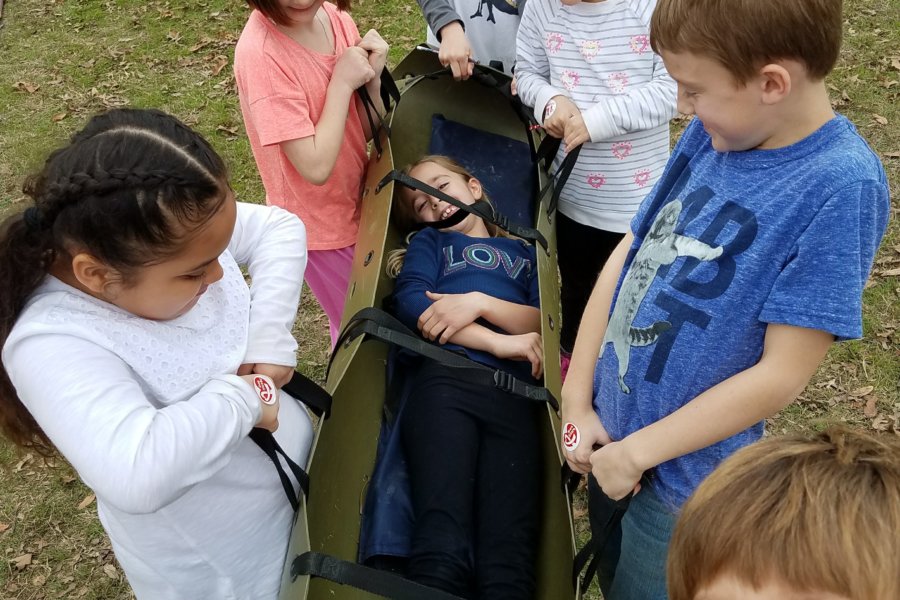 Austin, TX: practicing teamwork by carrying a friend in the cave rescue stretcher.