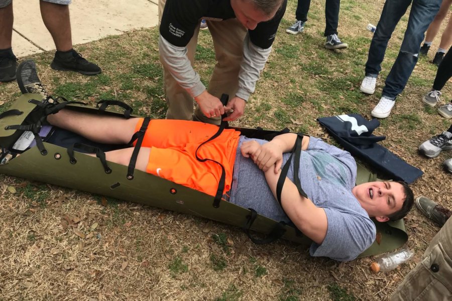 Austin, TX: A student prepares to be carried in a rescue stretcher