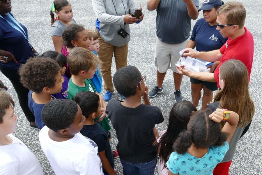 Austin, TX: Kids and staff enthralled by a CaveSim geology demo during a city program